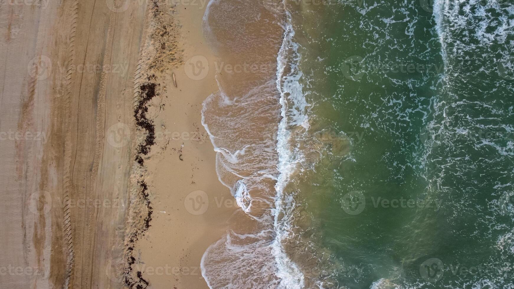 Top down view beach and mediterranean sea with waves. Aerial view abstract coastline in summer. Marina di Ostui, Puglia, Italy photo