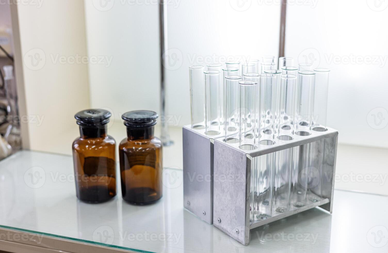 A glass table with a glass shelf and a metal stand photo