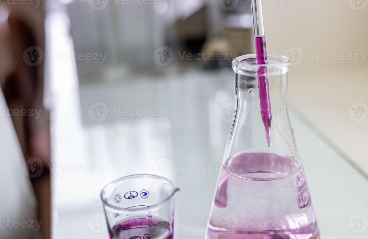 A beaker with a liquid in it and a glass photo