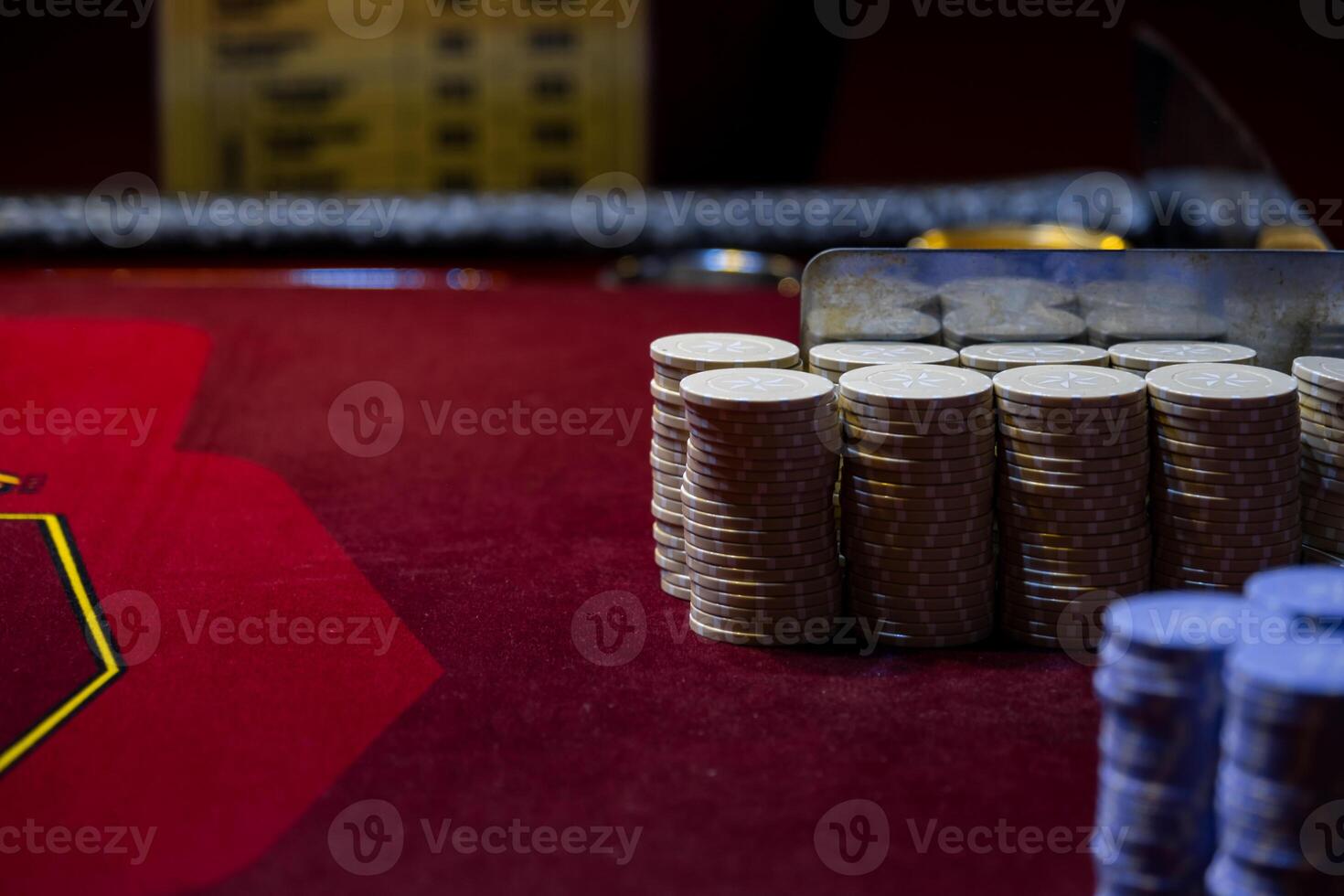 A pile of coins on a table with a poker chip photo