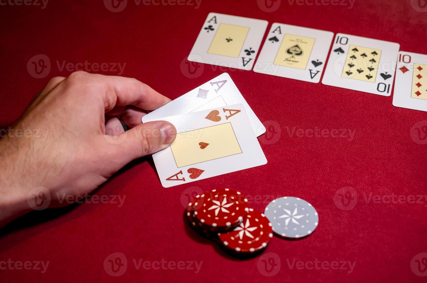 A person holding a card and playing cards photo