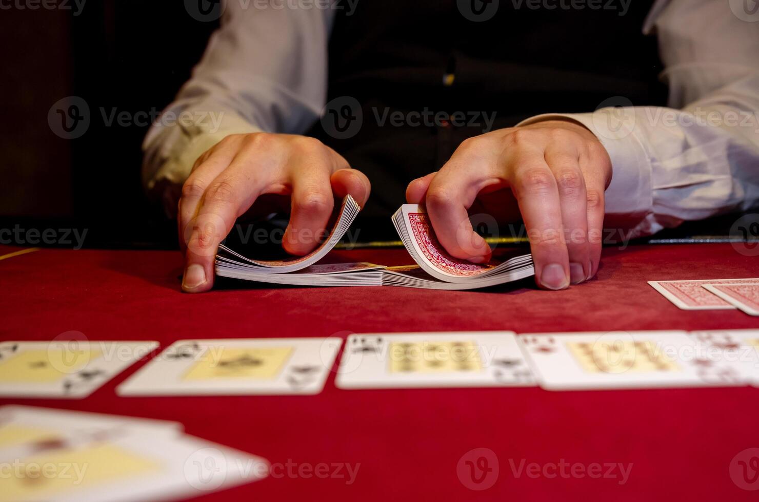A man playing cards on a table photo