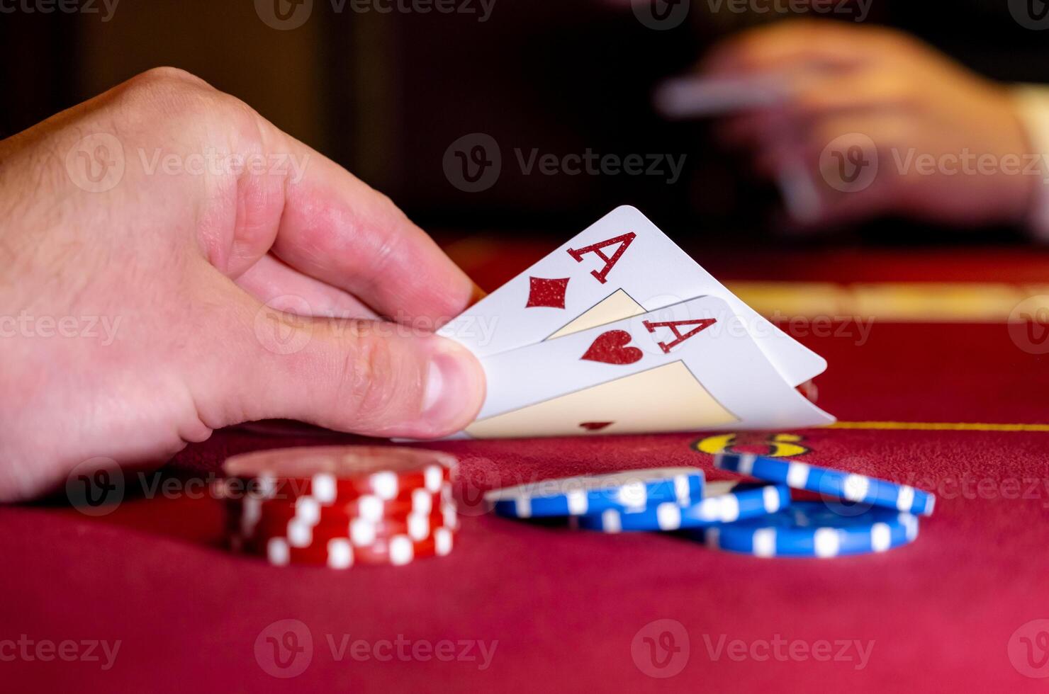 A person holding a pair of cards and playing cards photo