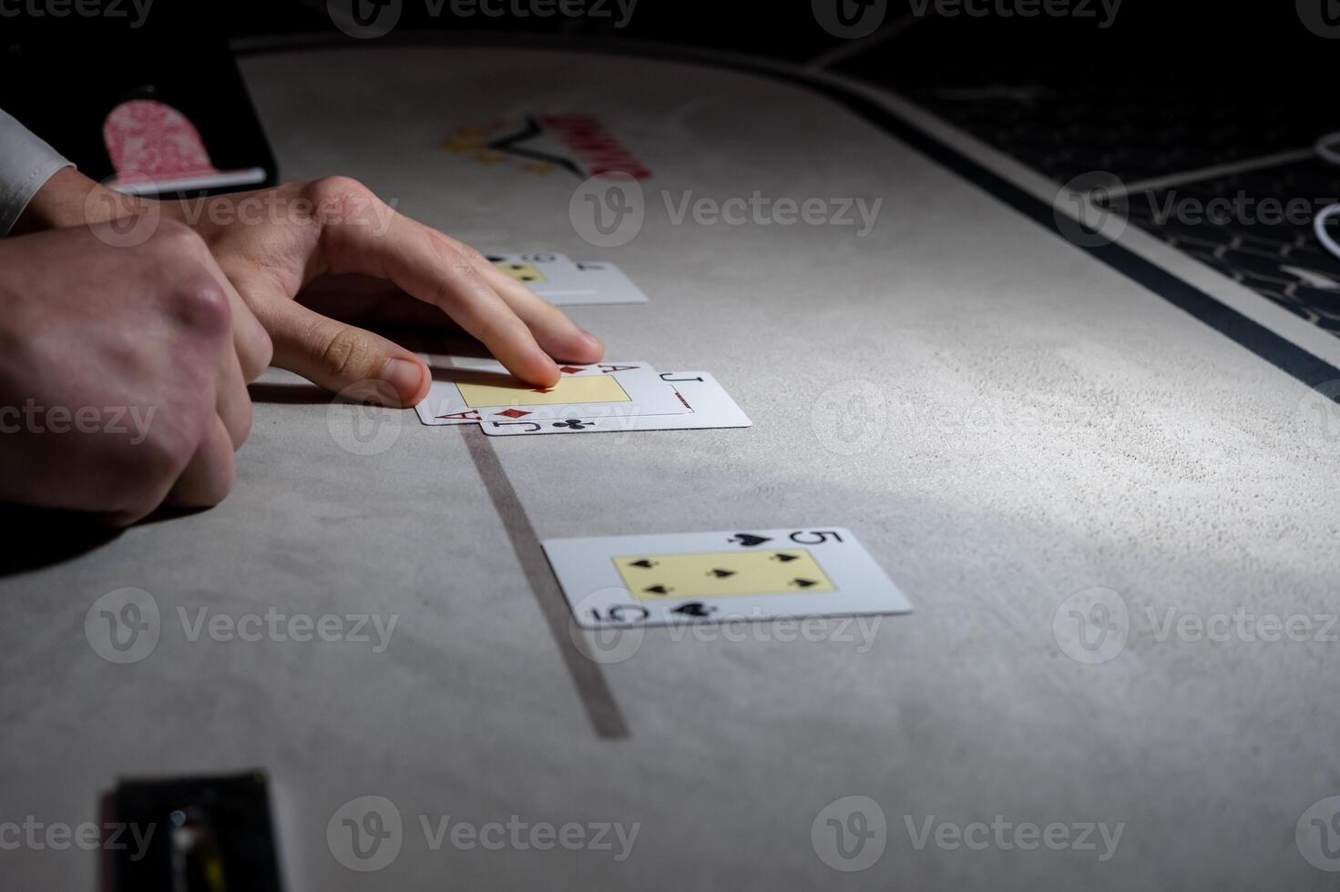 A person playing poker on a table with cards photo