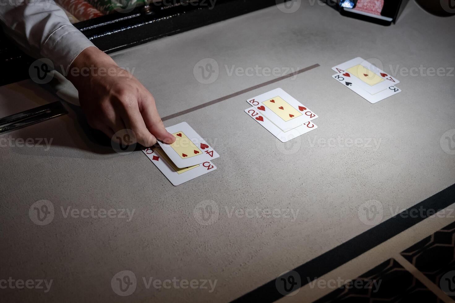 A person playing cards on a table photo