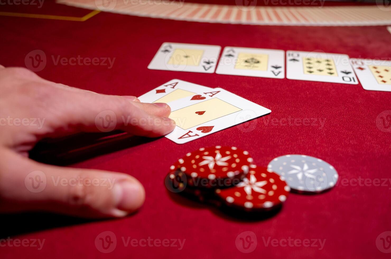 A person is holding a card and playing cards photo