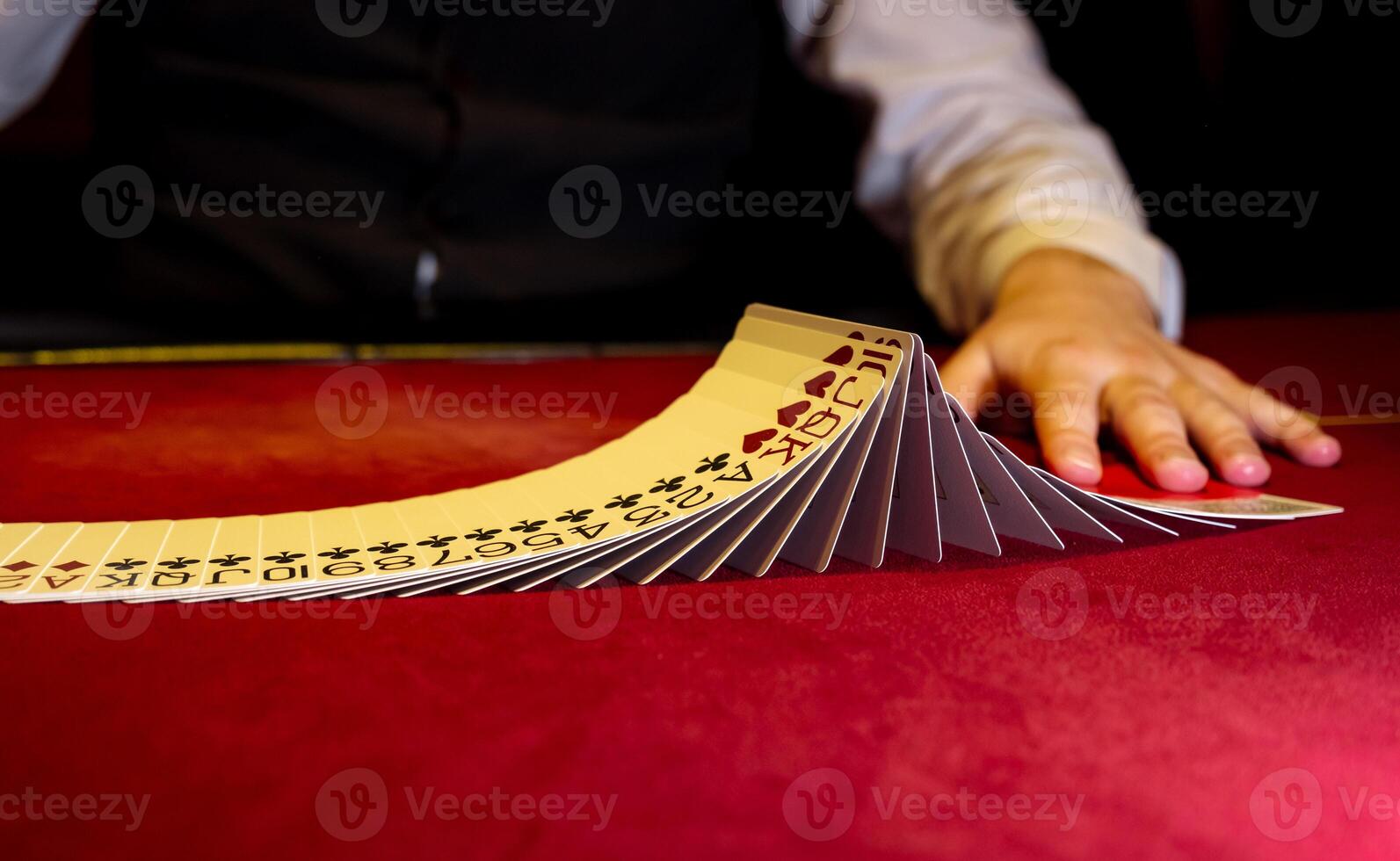 A person is holding a stack of cards on a table photo