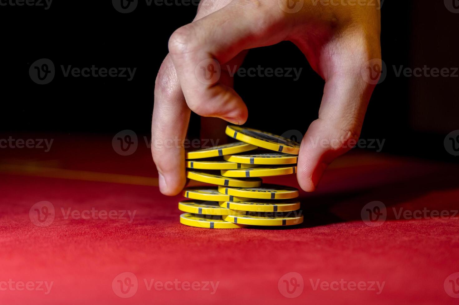A person holding a stack of poker chips photo