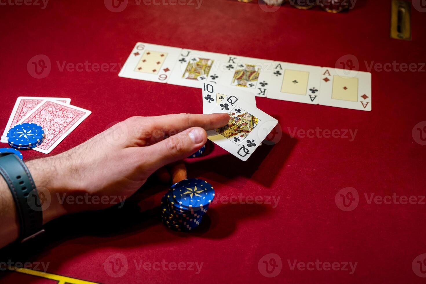 A person holding a pair of cards and playing cards photo