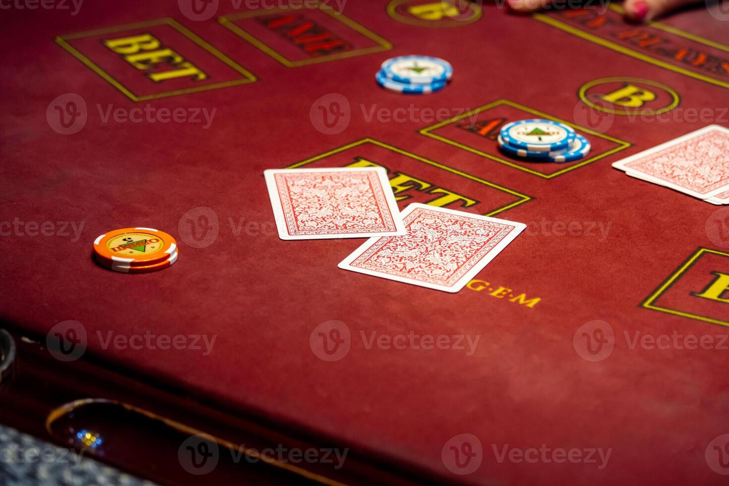 Casino. Black Jack card game. People play cards in a gambling establishment. Croupier hands dealing cards on t blackjack poker table, gambling table with cards and chips. photo