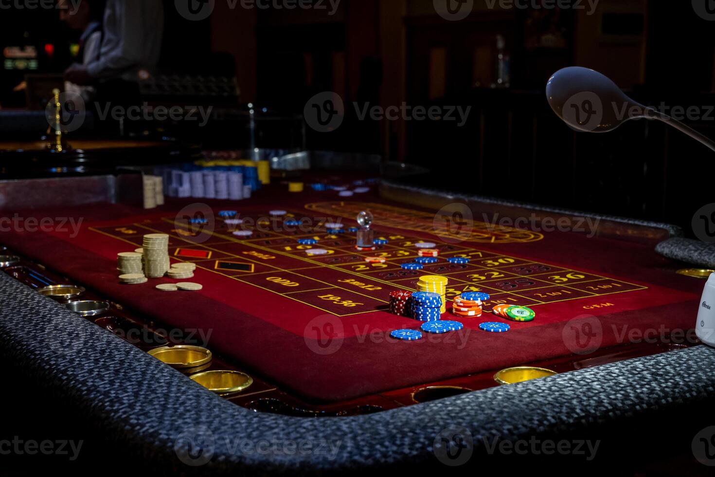 A table with a craps game and a light photo