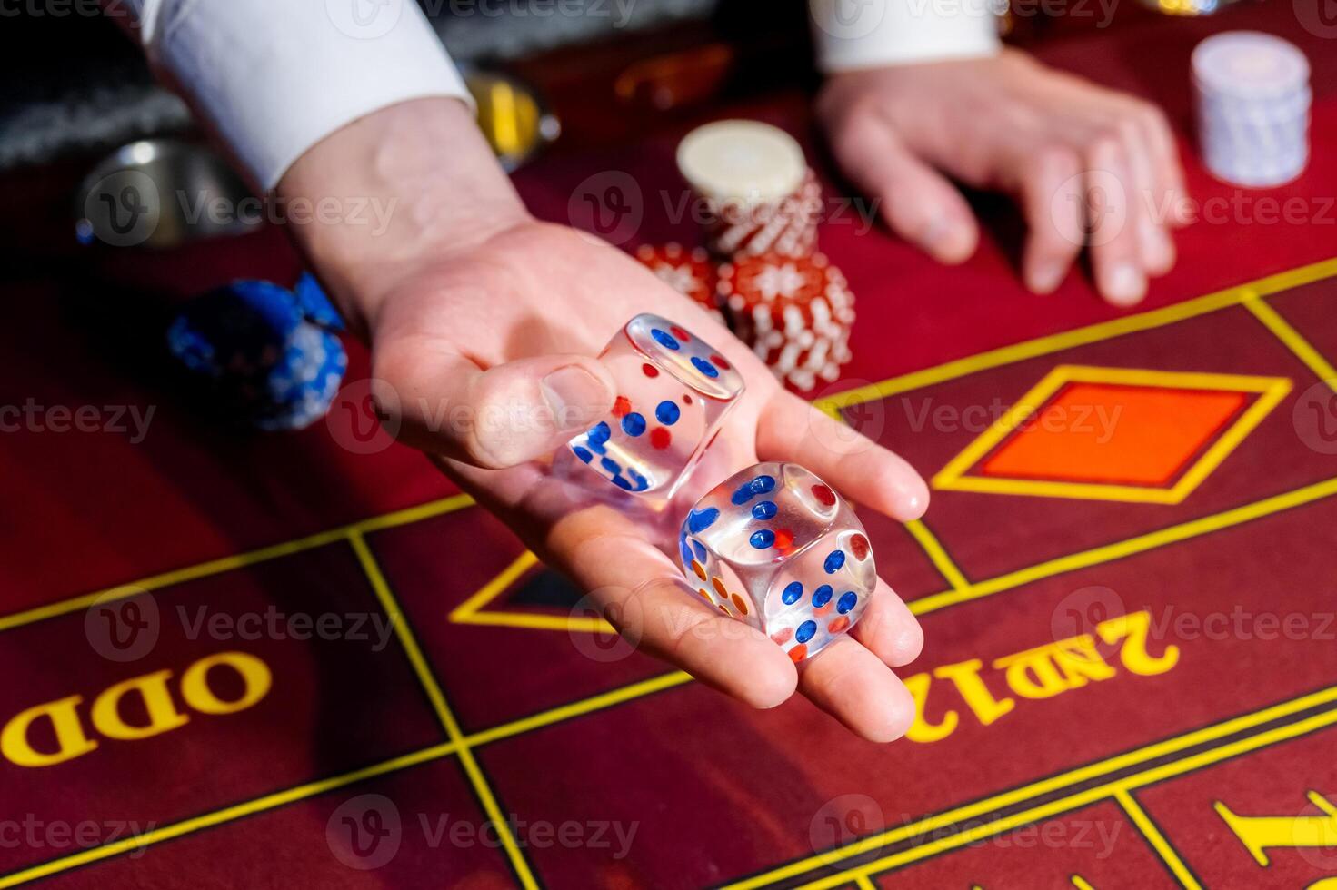 A person holding a dice on a roulette table photo