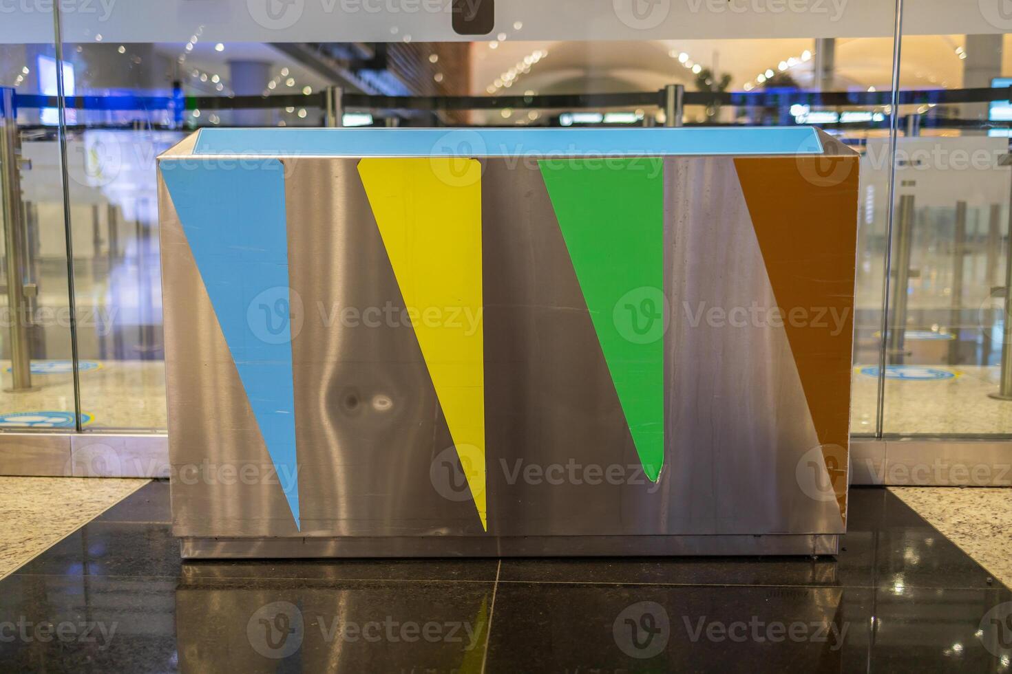 Close-up of green, blue, and red trash cans for separate dumping of glass, paper, and other trash in the store. Concept of proper waste disposal. photo