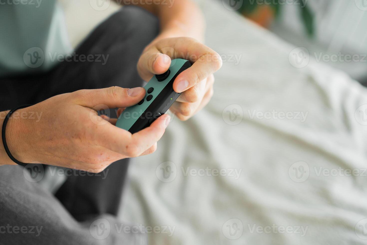 Man playing on the game console. Holding hands gamepad, game controller photo