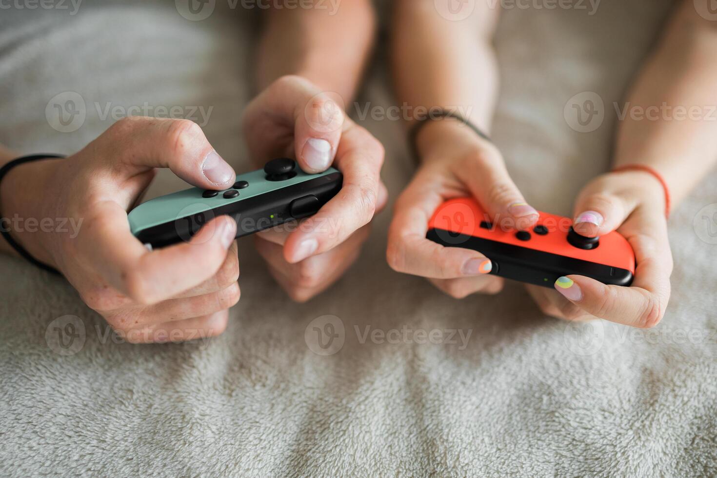 Woman and man playing on the game console. Holding hands gamepad, game controller photo