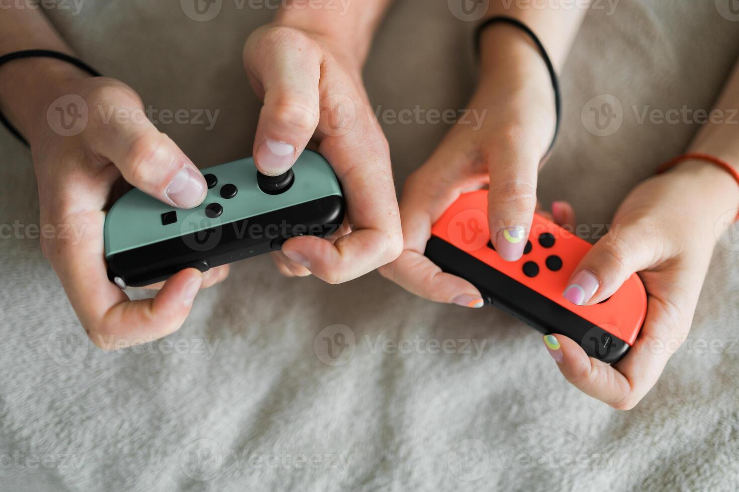 Woman and man playing on the game console. Holding hands gamepad, game controller photo