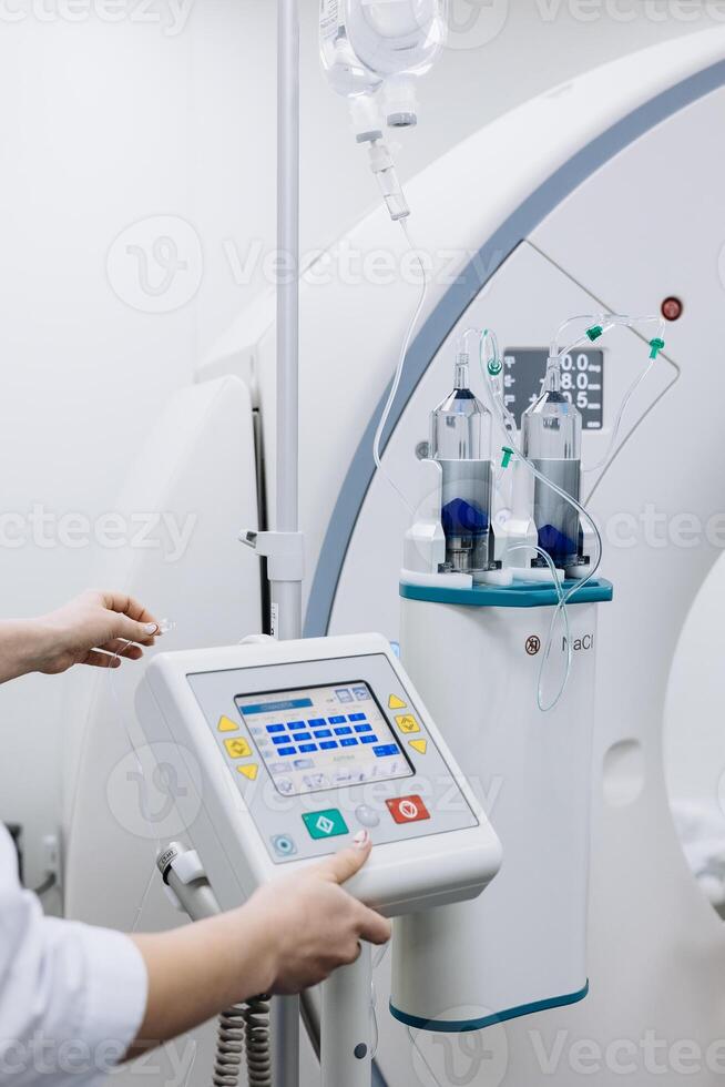Close-up of control panel CT. A medical technician assists a patient undergoing an MRI scan, showcasing professionalism and modern medical technology in a healthcare setting. Vertical shot photo