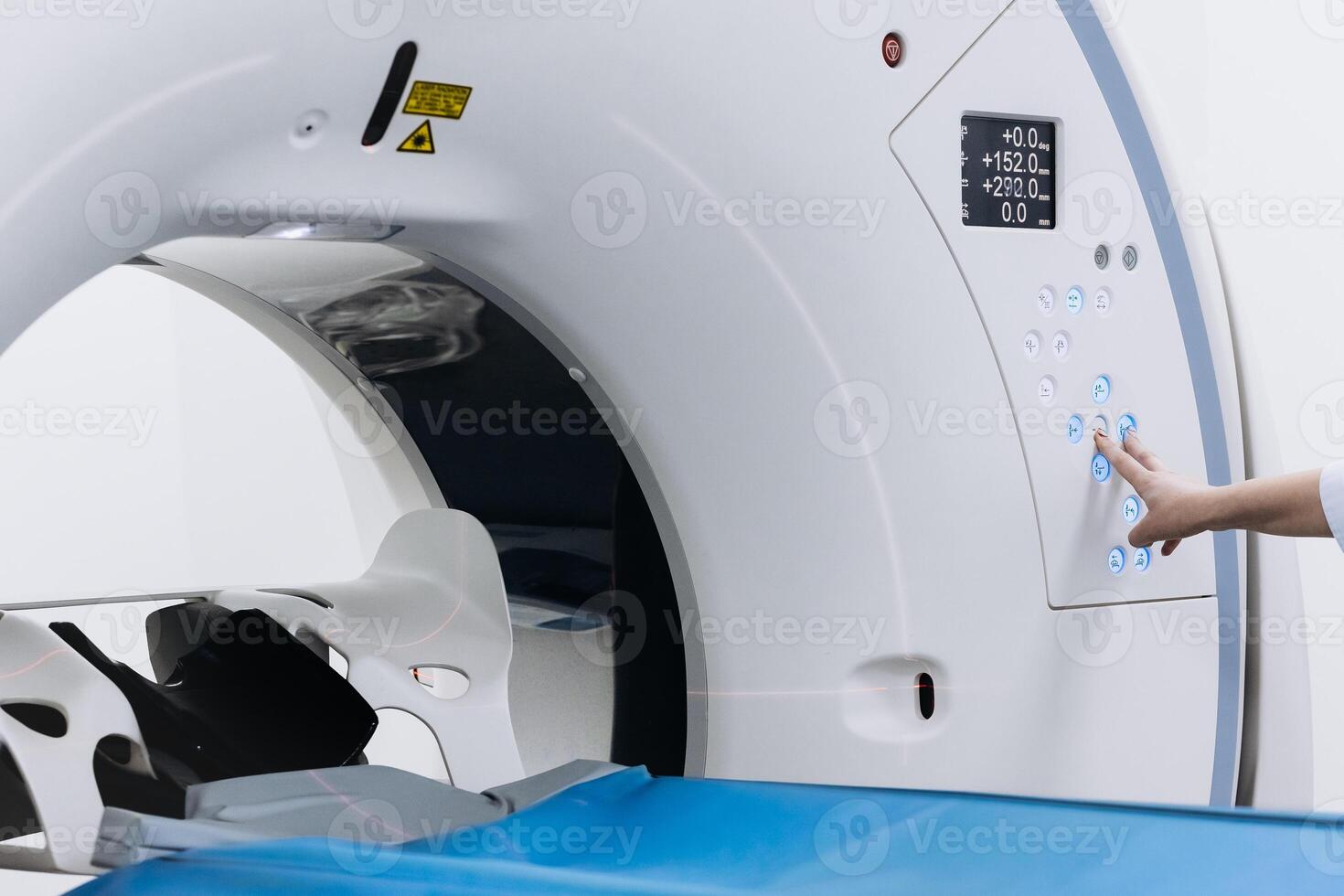 Doctor conducts check up procedure in clinic with advanced medical technologies. High-tech modern medical equipment. MRI or CT or PET scan machine. photo