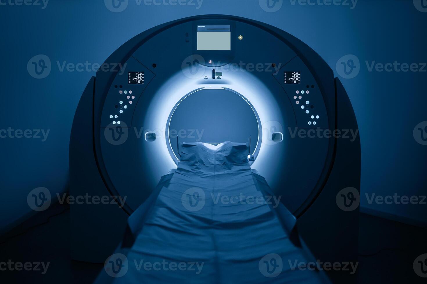Medical CT or MRI Scan in the modern hospital laboratory. Interior of radiography department. Technologically advanced equipment in white room. Magnetic resonance diagnostics machine. Blue backdrop photo