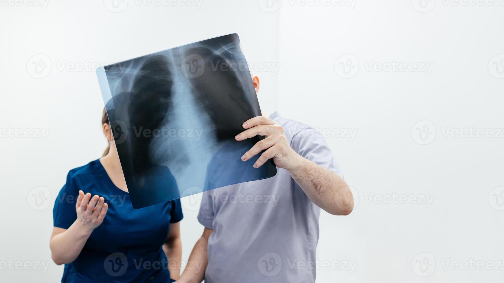 Two doctors in an MRI or CT room reviewing images and discussing the results. The concept of teamwork and precise analysis for diagnosing conditions of organs and the bone system. Copy space, banner photo