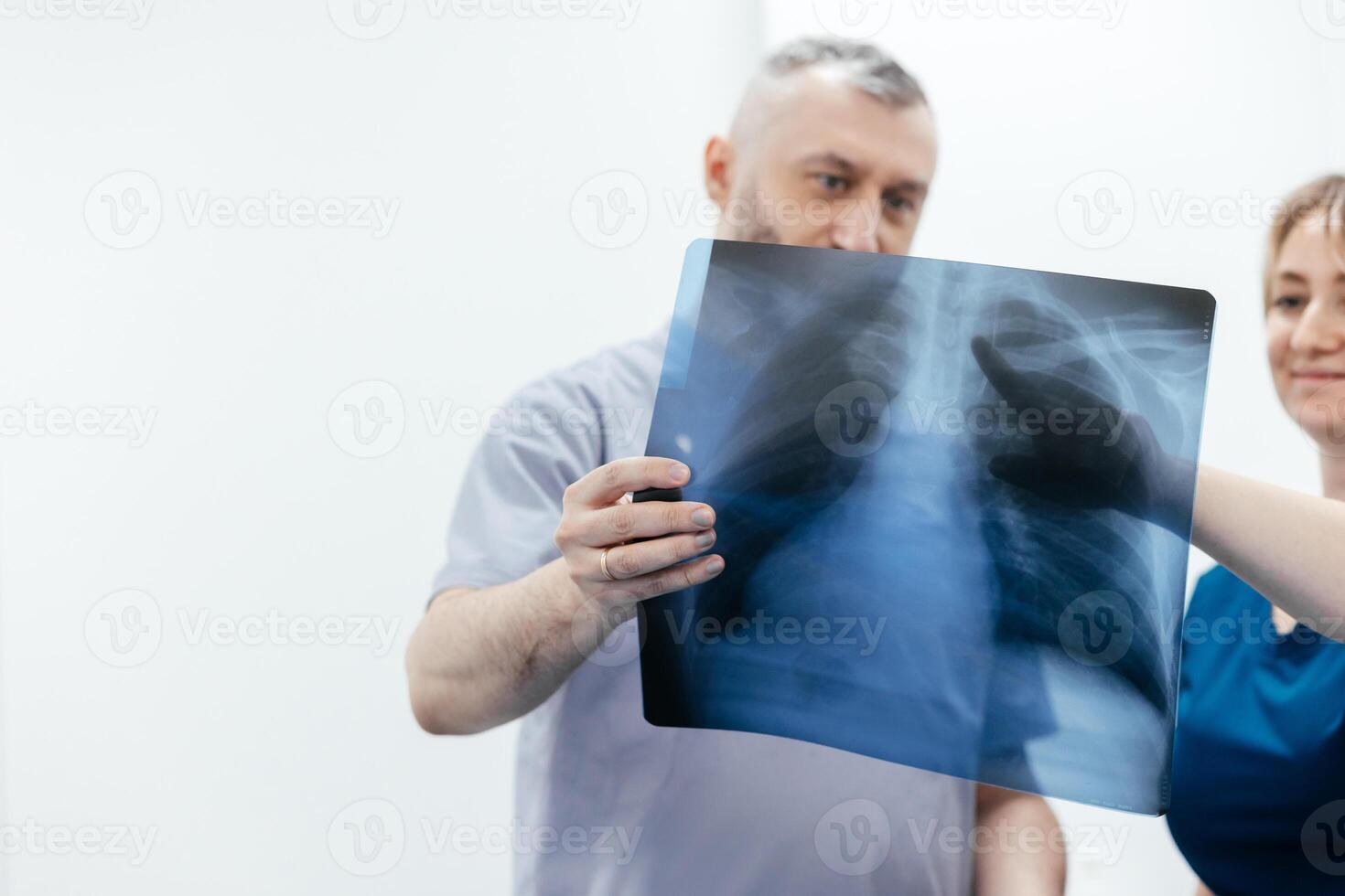 A doctor and specialist in an MRI or CT room analyze images, discussing the examination results. The concept of effective teamwork for accurate diagnostics and optimal treatment. photo