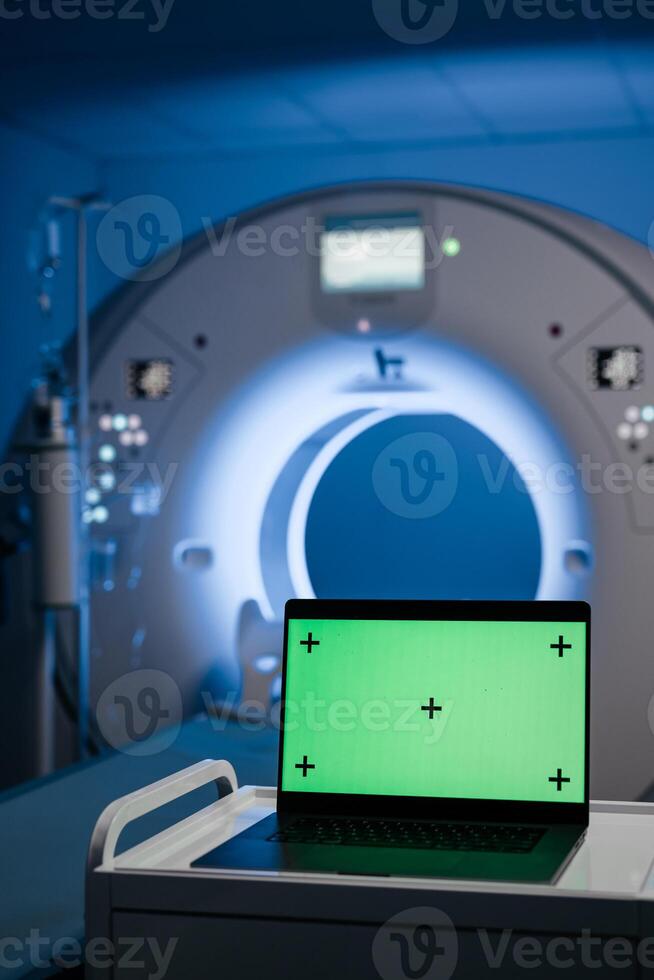 MRI room with a green screen for text display, set against CT or MRI equipment. Concept of cutting-edge technologies and innovations in medical research and diagnostics. Banner, advertising, mock-up photo