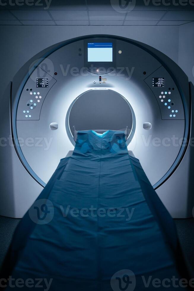 Medical CT or MRI or PET Scan Standing in the Modern Hospital Laboratory. Technologically Advanced and Functional Medical Equipment in a Clean White Room. Vertical shot, blue background photo