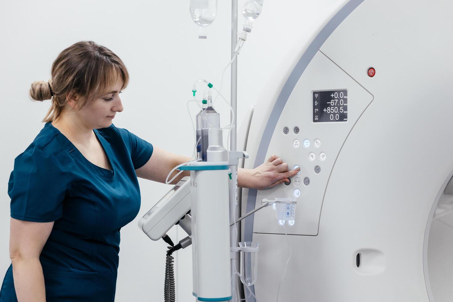 A medical nurse, doctor push buttons of a modern MRI scanner while attending to a patient in a medical facility. The scene highlights advanced technology and healthcare support for diagnostic imaging photo