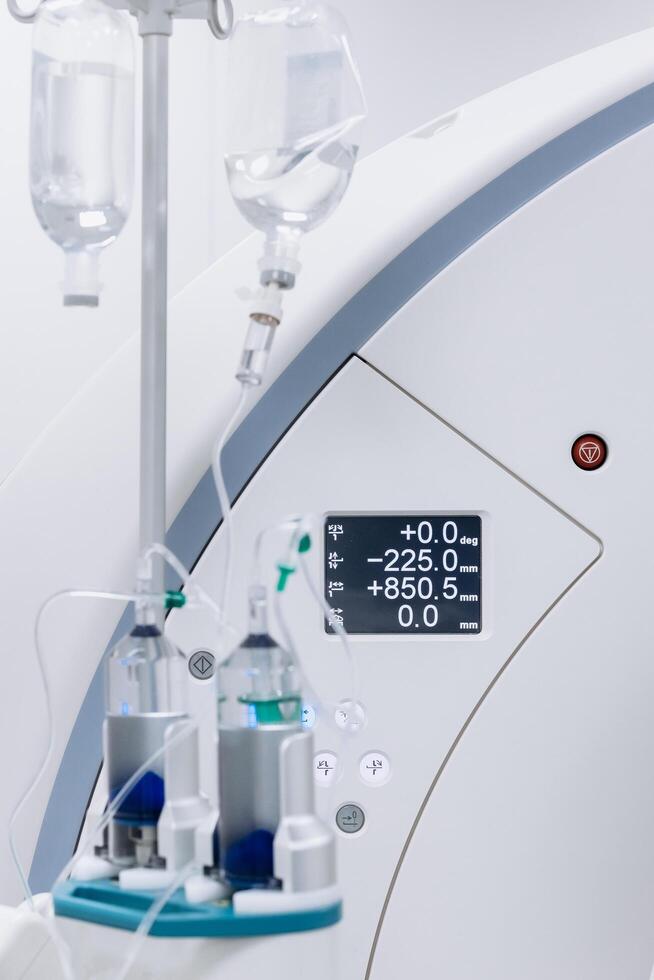 Close-up of a contrast agent before diagnostics in a CT room. The concept of using innovative technologies for accurate vascular examinations and disease diagnostics. Medicine concept, Vertical shot photo