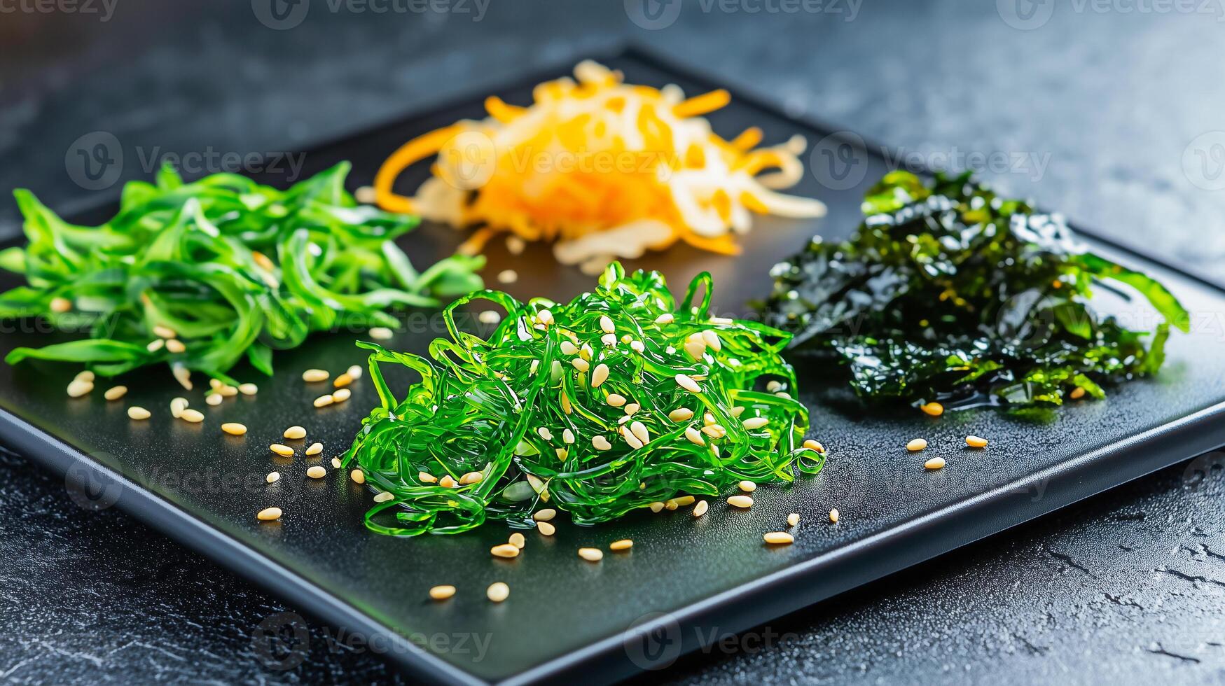 Colorful assortment of seaweed salads on a modern black plate. photo