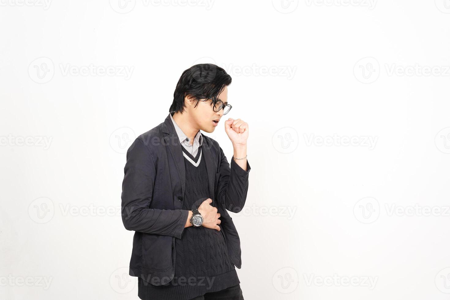 A man in glasses and a sweater standing against a white wall photo