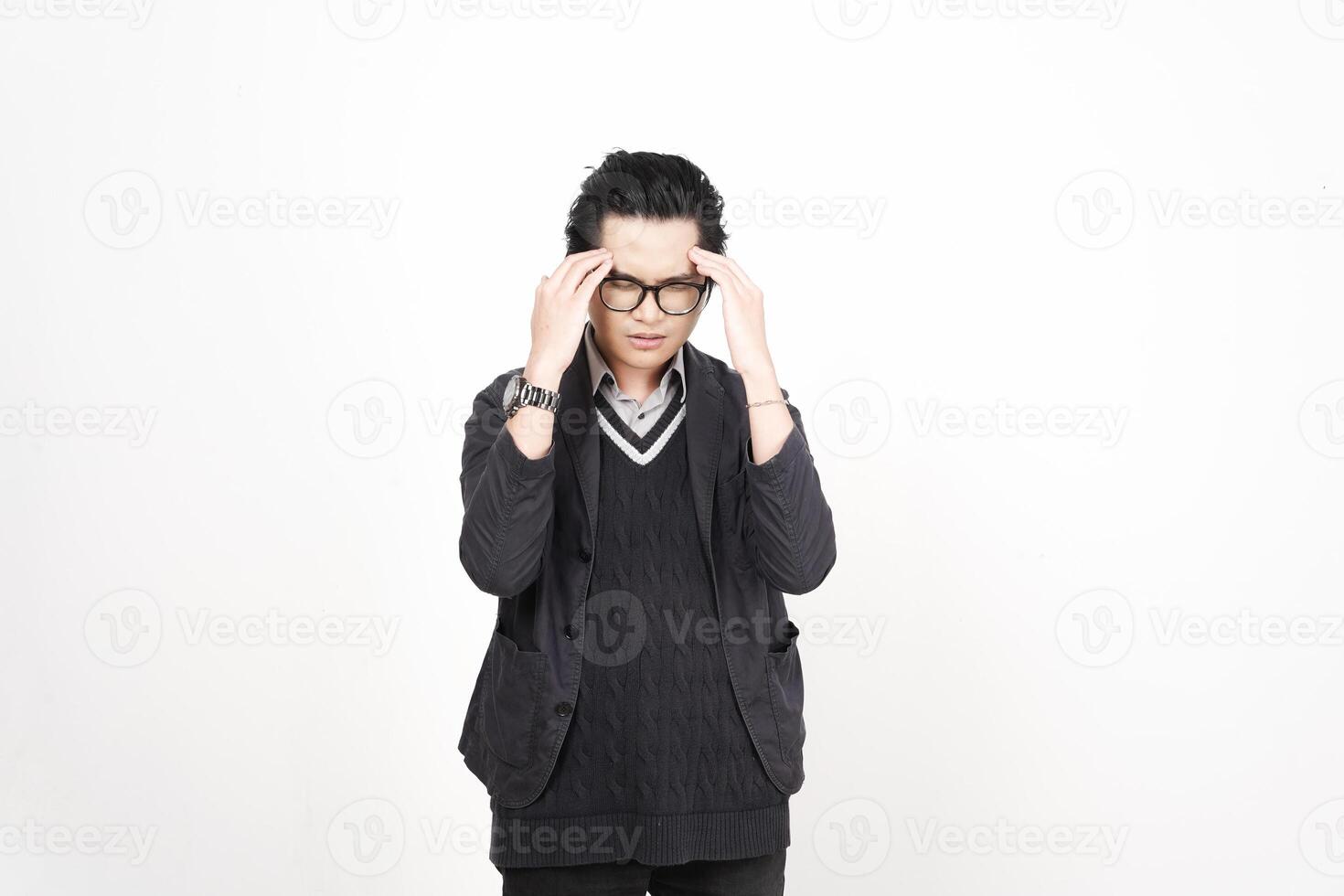 A man with glasses and a sweater is holding his head photo