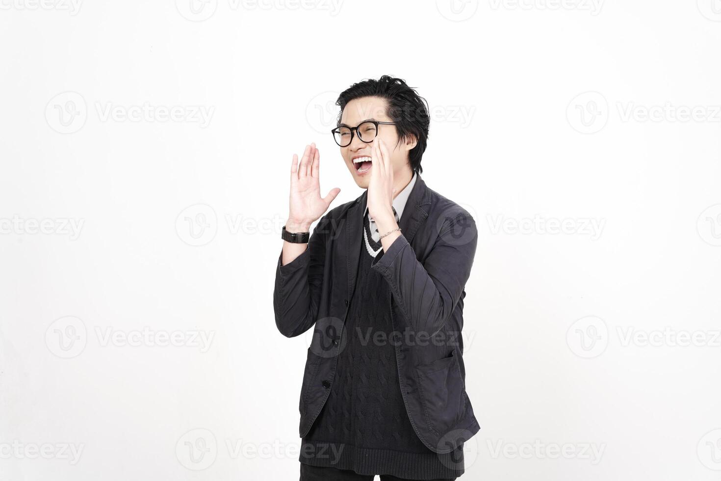 A man in glasses and a black jacket is making a gesture photo