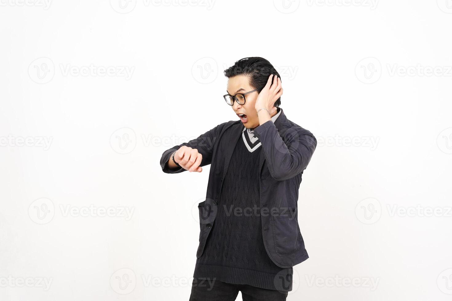 A man in glasses and a sweater is holding his hand to his ear photo