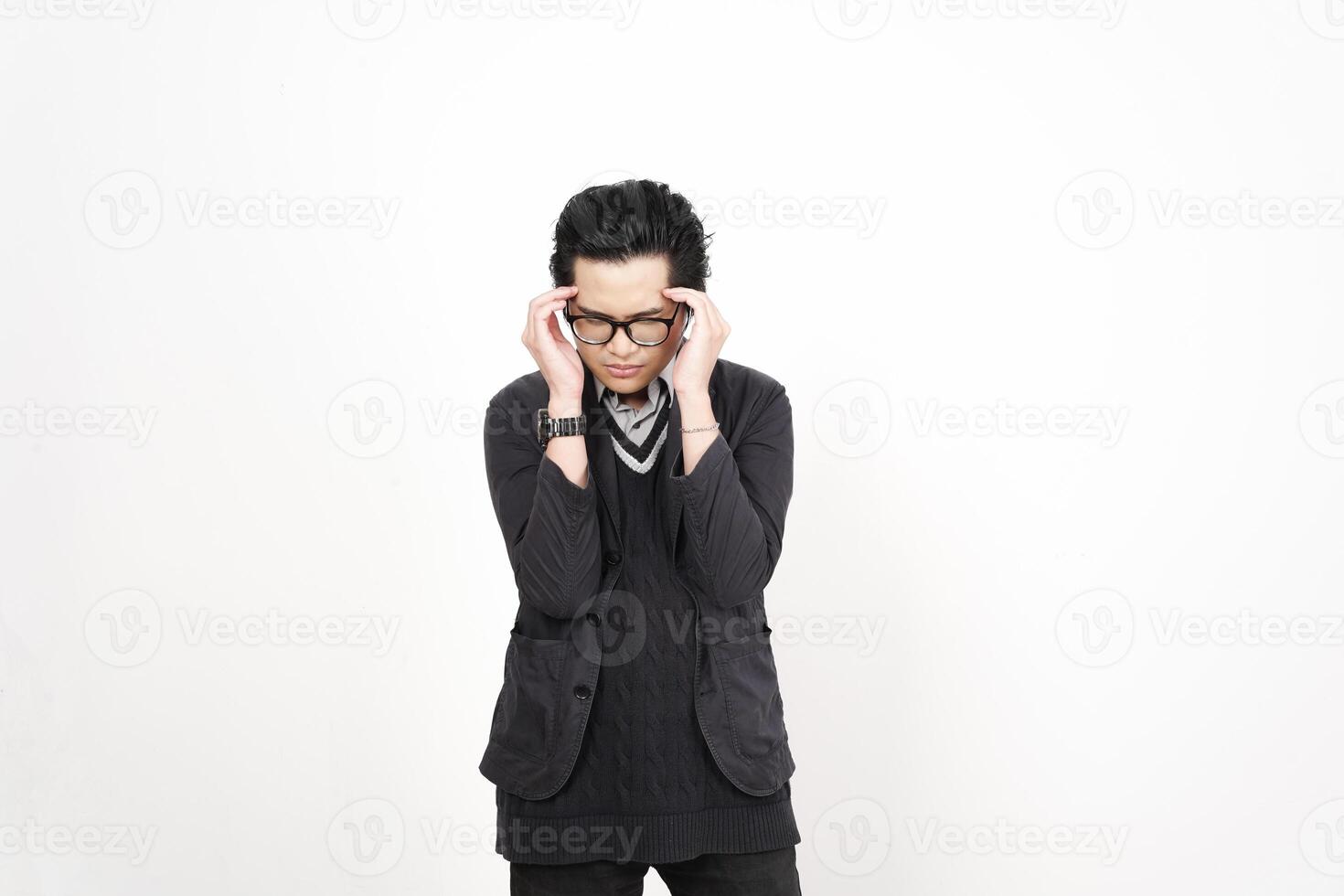 A man in glasses and a sweater is holding his head photo
