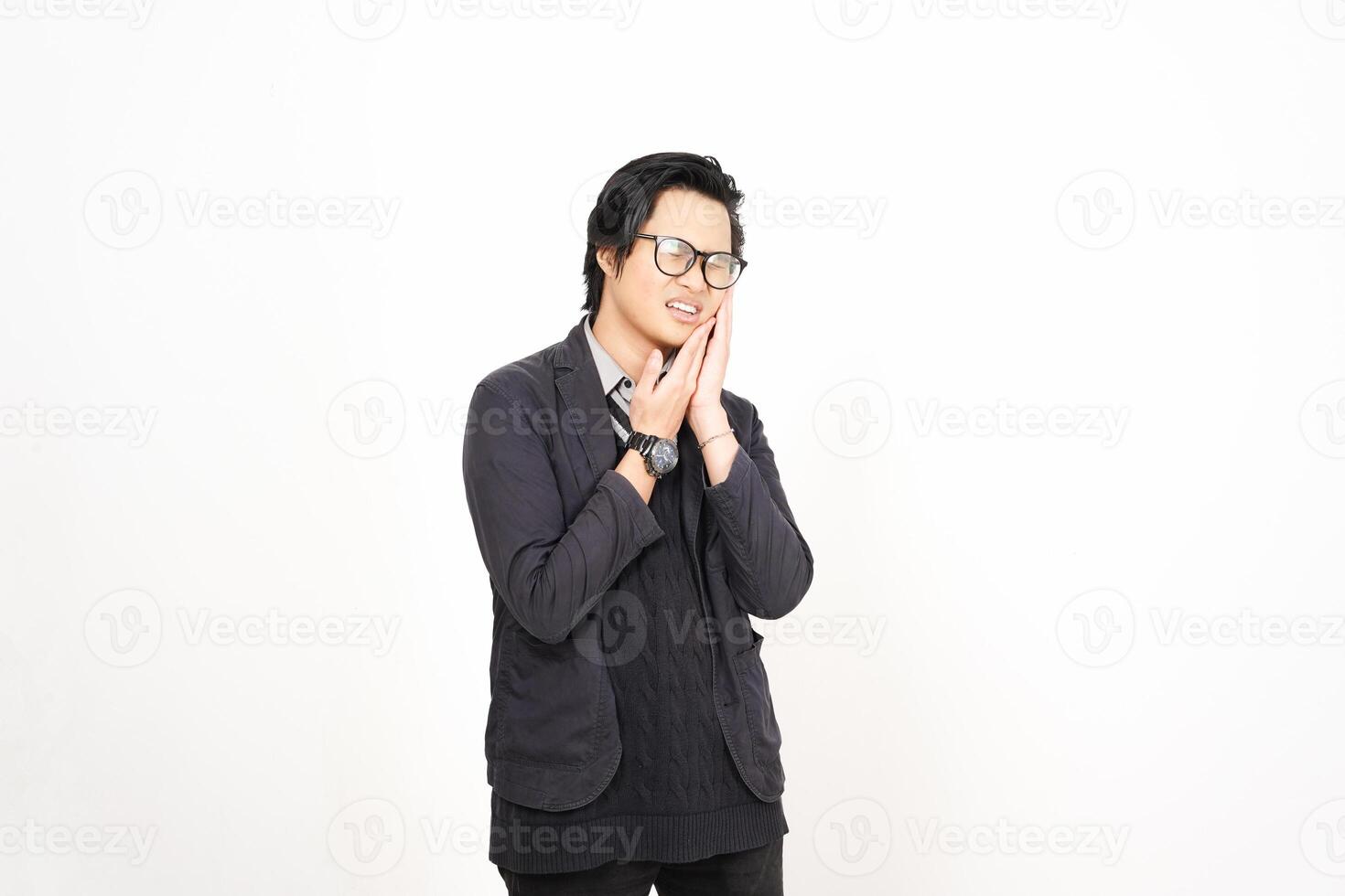 A man in glasses and a jacket standing in front of a white background photo