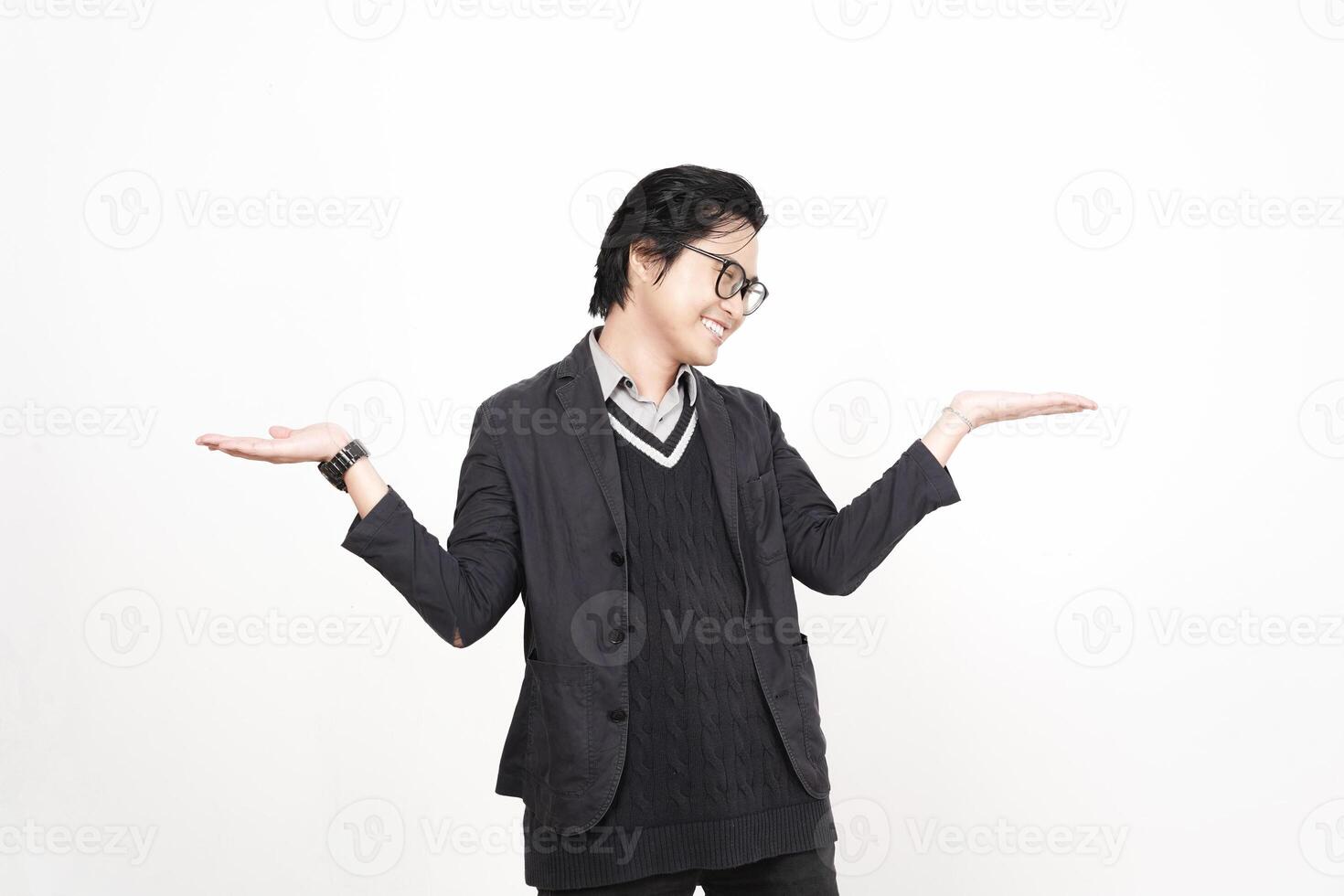 A man in glasses and a jacket is holding something out photo