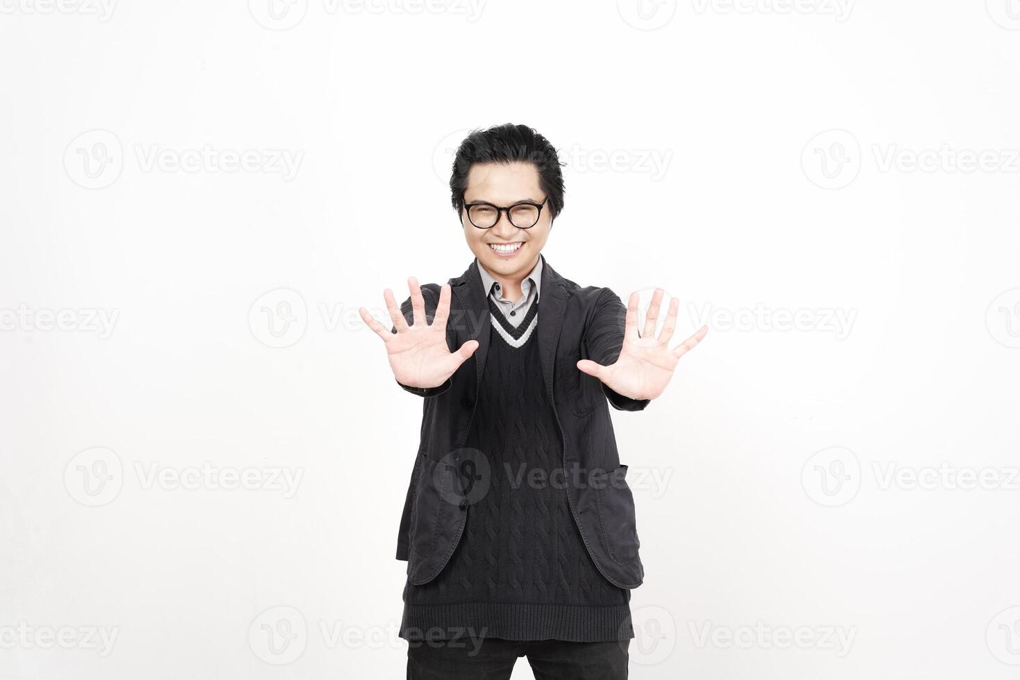 A man in glasses and a sweater is making a stop sign photo