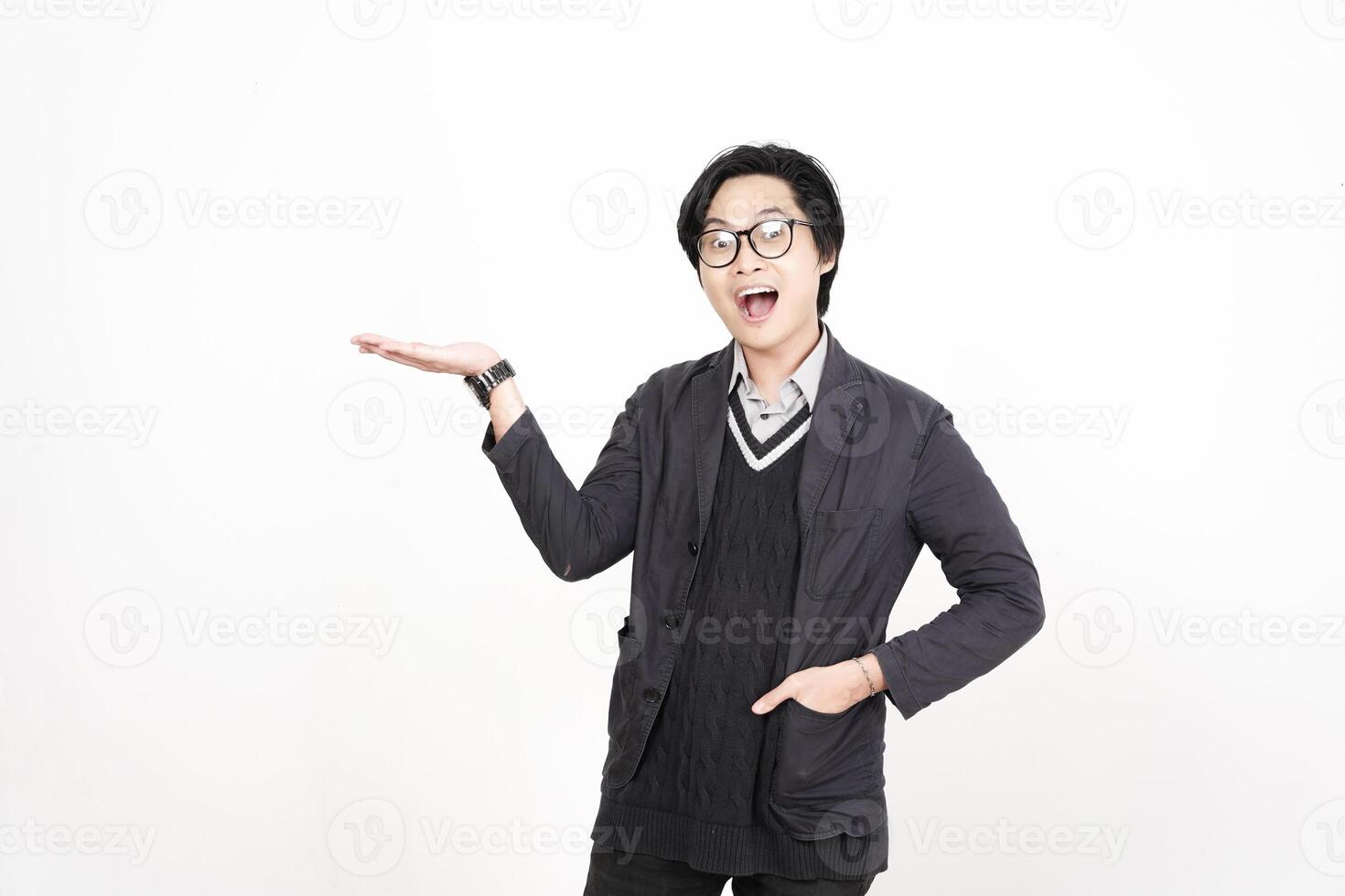 A man in glasses and a sweater is holding something photo