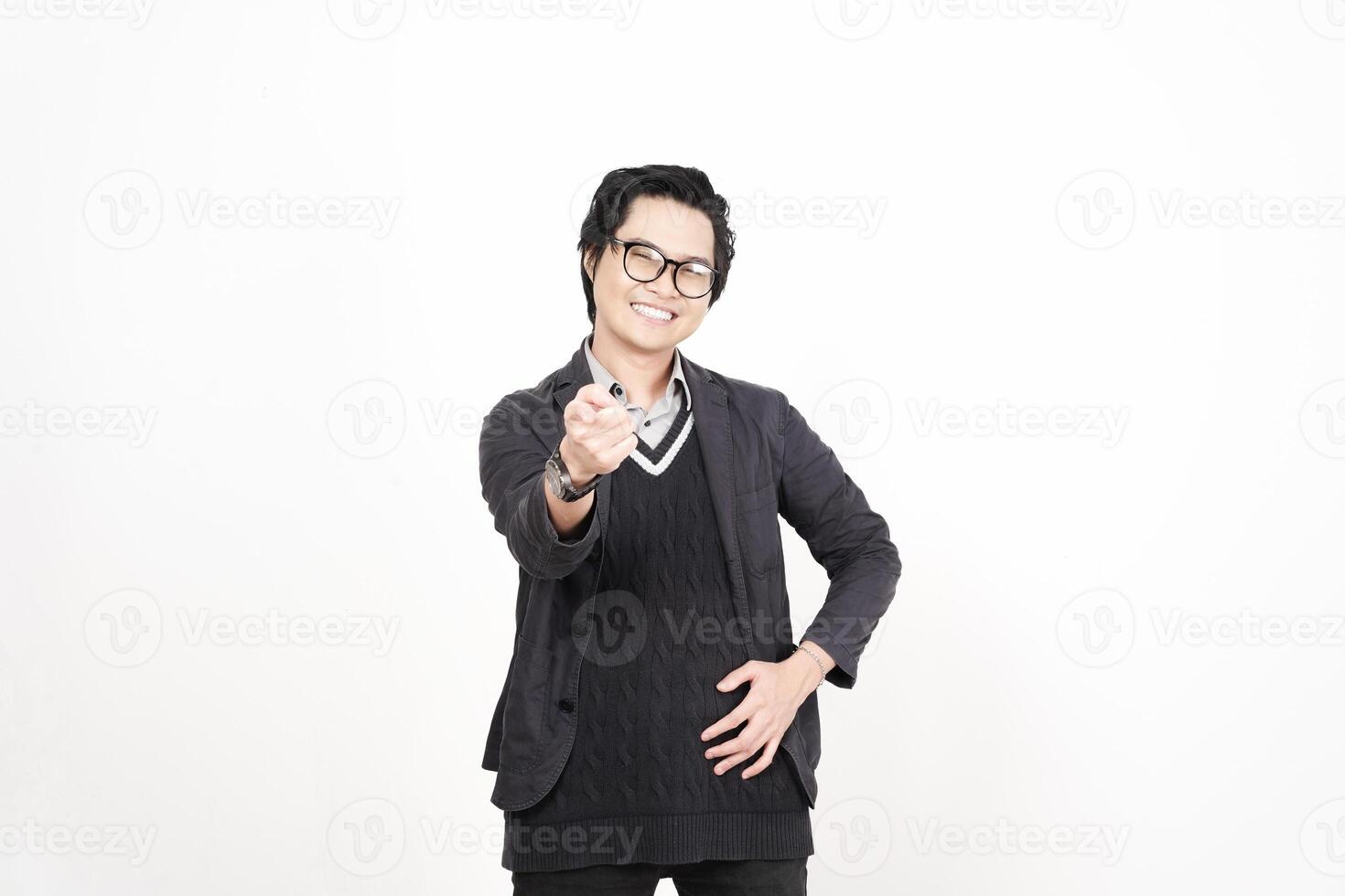 A man in glasses and a sweater is pointing at something photo