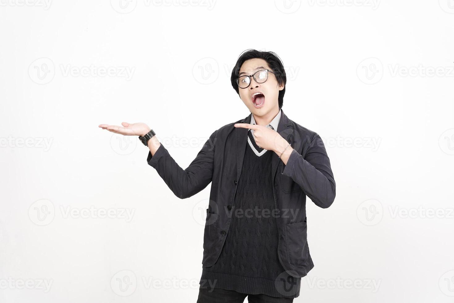 A man in glasses and a sweater is pointing to something photo