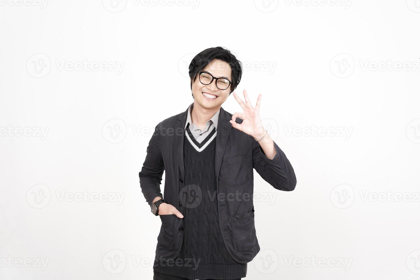 A man in glasses and a sweater is making a peace sign photo