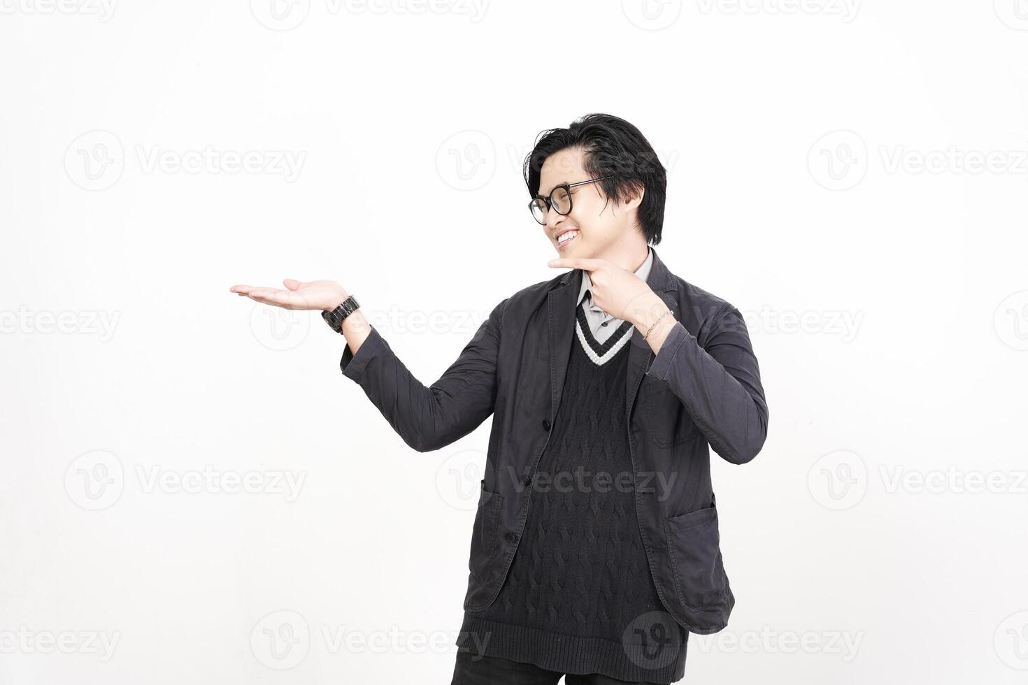 A man in glasses is pointing at something photo
