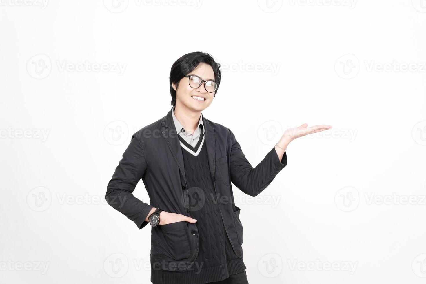 A man in glasses and a sweater is holding something photo