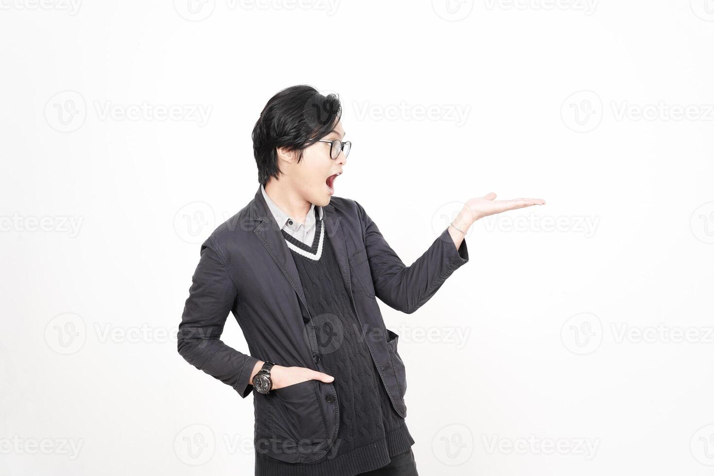 A man in glasses and a jacket is pointing at something photo