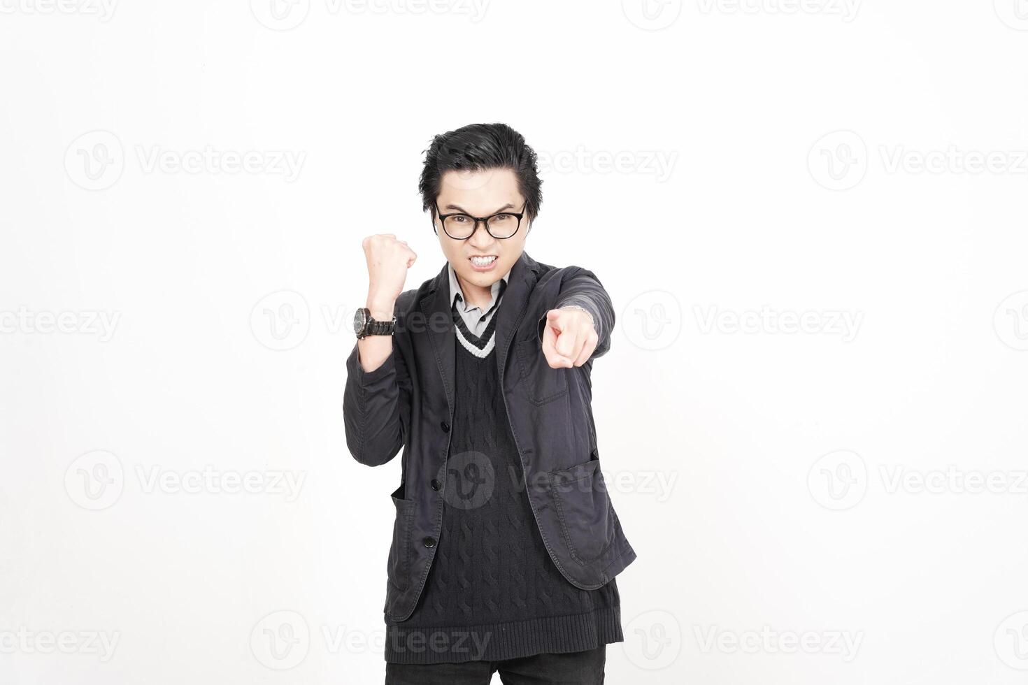A man in glasses and a black jacket pointing at something photo
