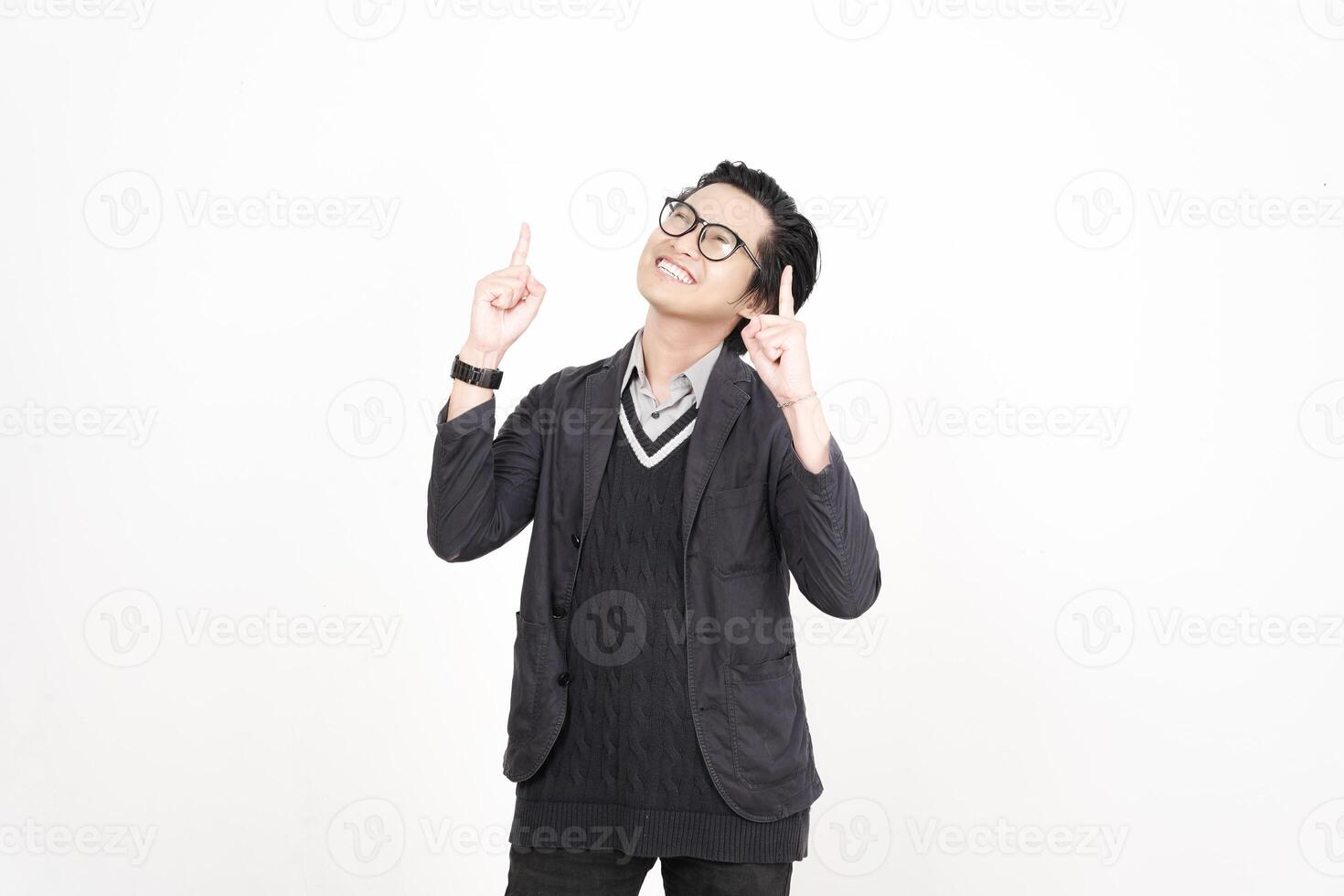 A man in glasses and a sweater is pointing up photo