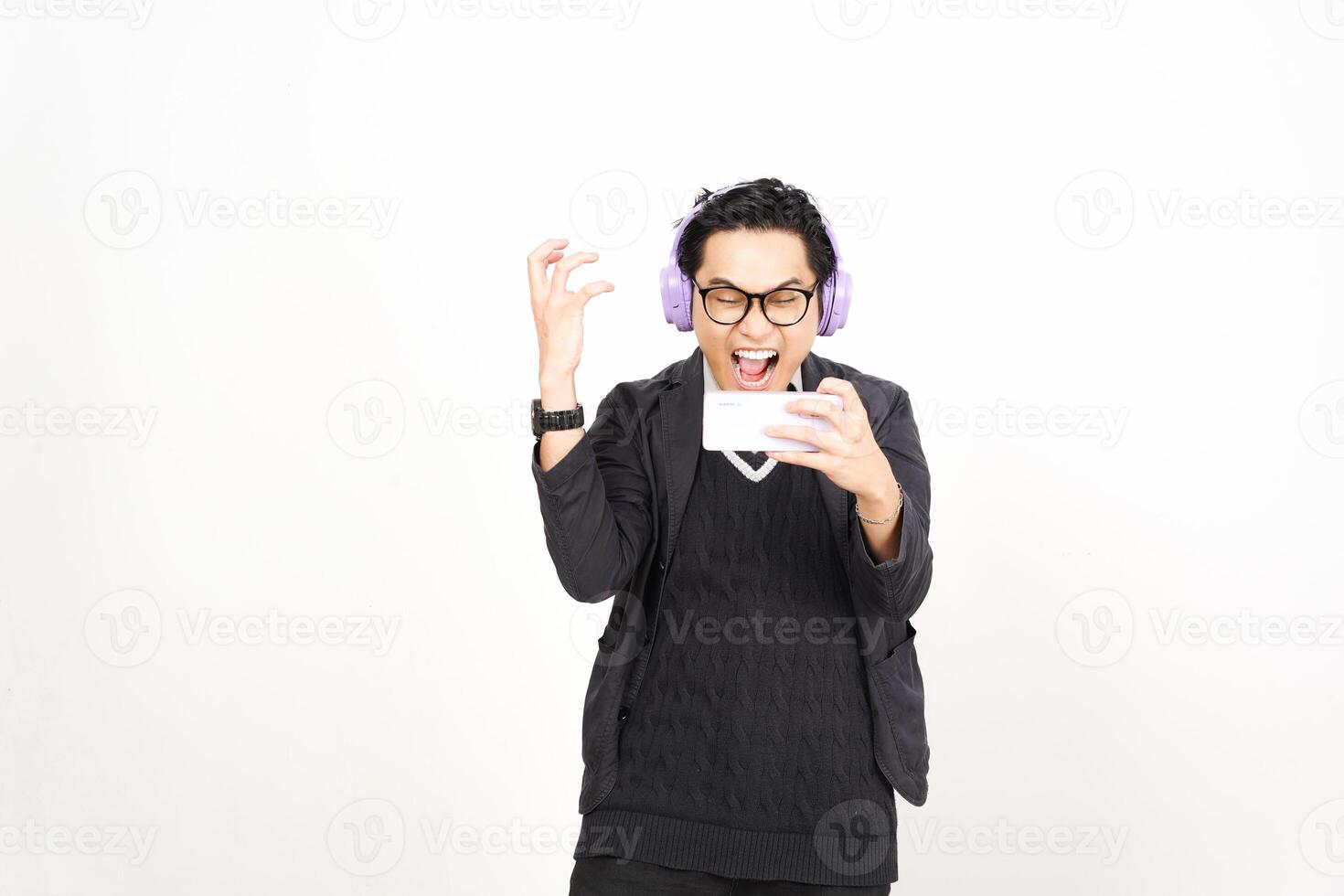 A man in headphones holding a phone and smiling photo