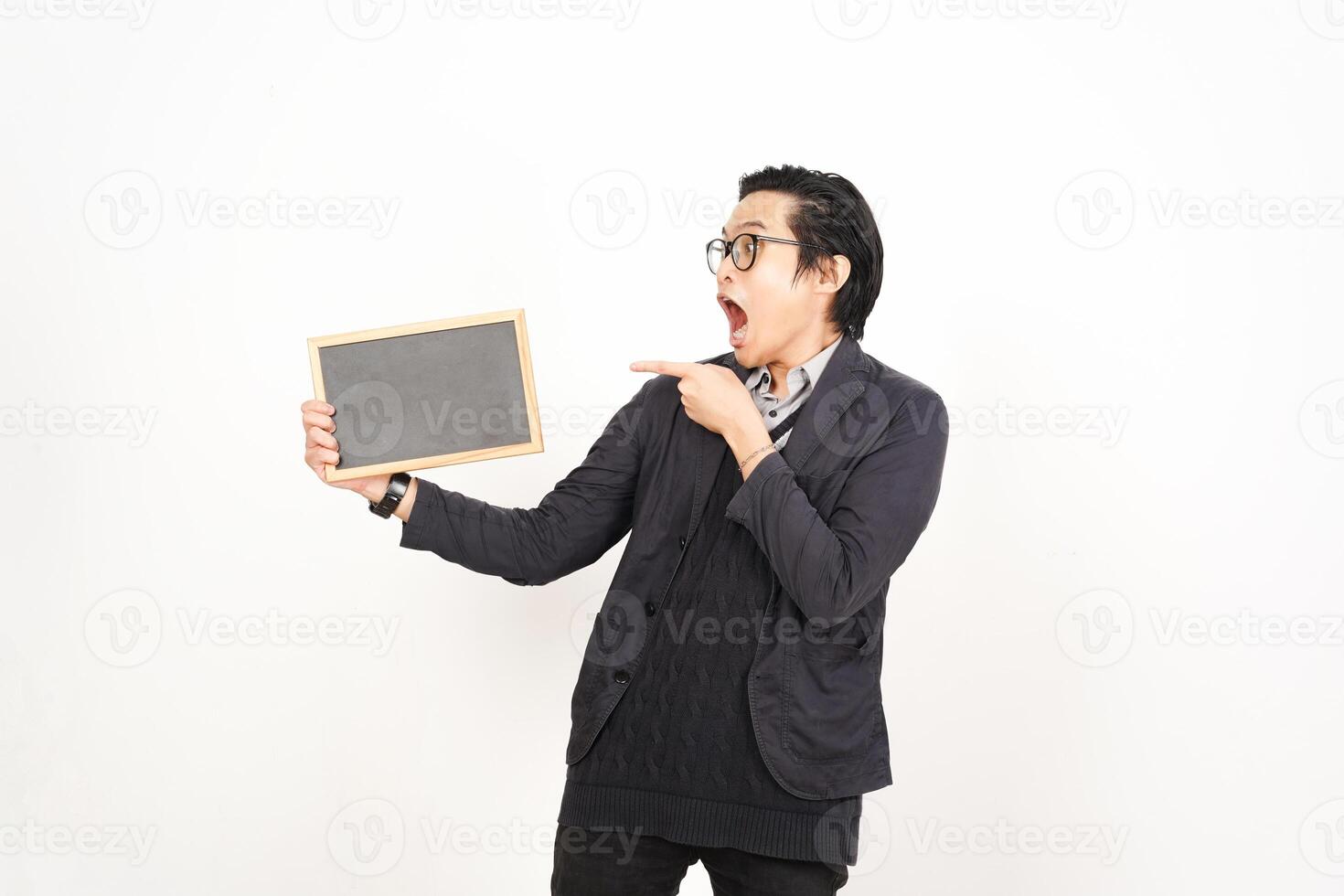 A man holding a blackboard and pointing at it photo