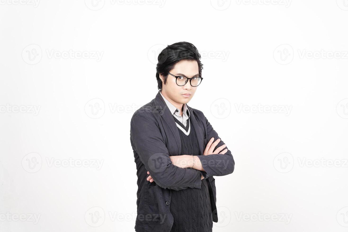 A man in glasses and a suit standing with his arms crossed photo